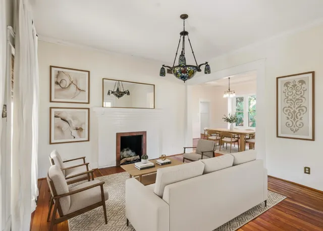a living room with furniture and a chandelier