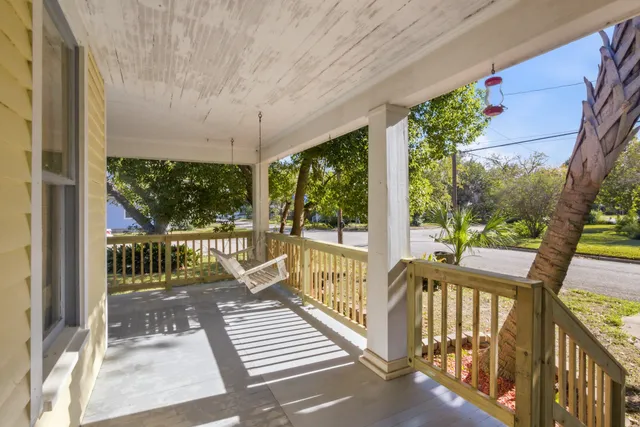 a view of a balcony with wooden floor