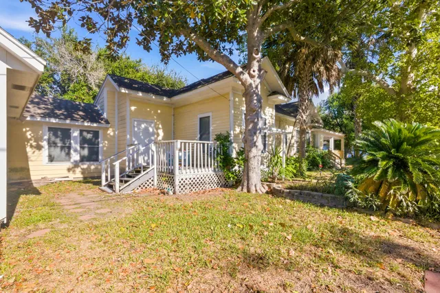 a view of a house with a tree in the background