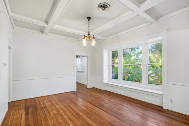 a view of a room with wooden floor fan and a window