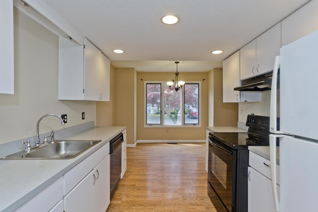 610 County Road, Unit 7 Holyoke, MA 01040 - Photo 5 of 24 a kitchen with a sink stove and refrigerator
