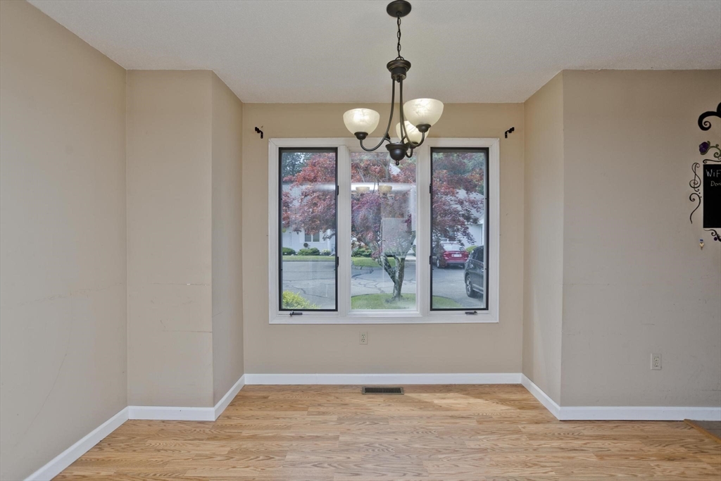 610 County Road, Unit 7 Holyoke, MA 01040 - Photo 7 of 24 a view of an empty room with a window and wooden floor