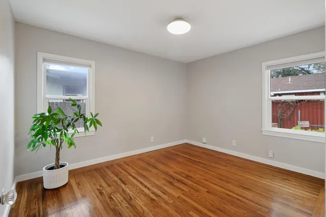 a view of a hallway with windows and chandelier