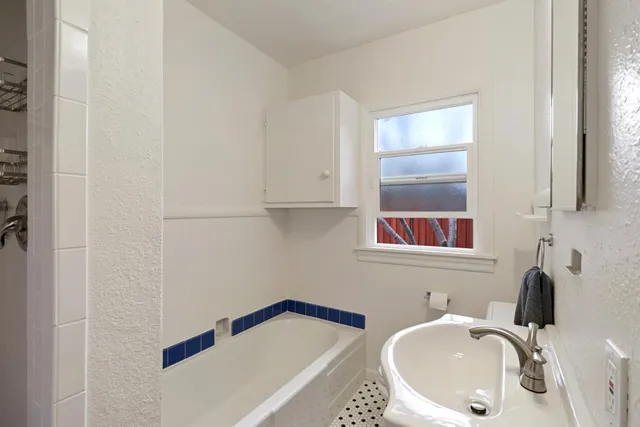 a bathroom with a bathtub and a sink