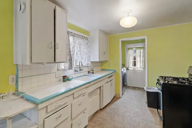 a kitchen with a refrigerator and a sink
