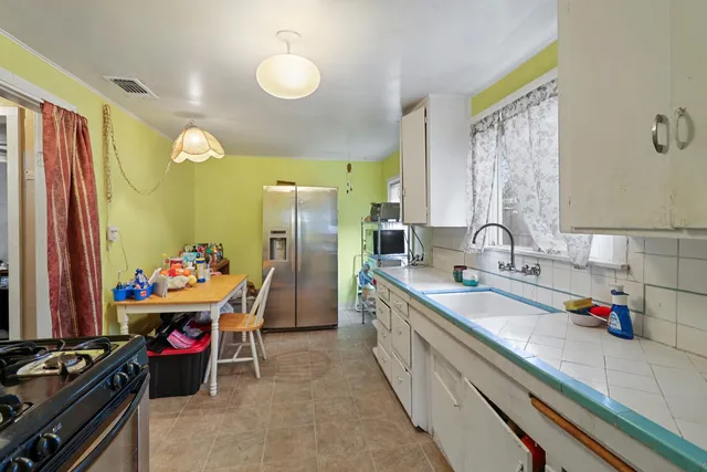 a bathroom with a sink a toilet and shower curtain