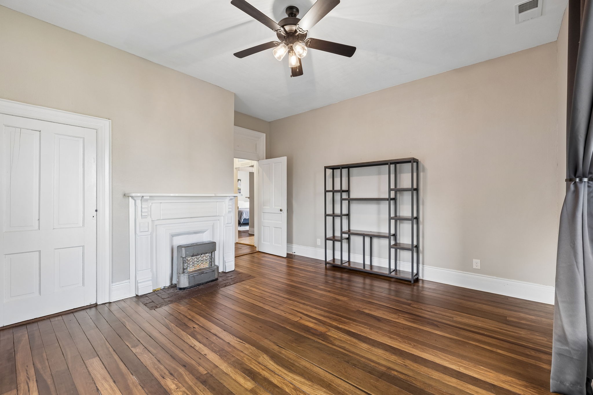 504 5th Avenue West Springfield, TN 37172 - Photo 34 of 57 wooden floor in an empty room with a fireplace and a window