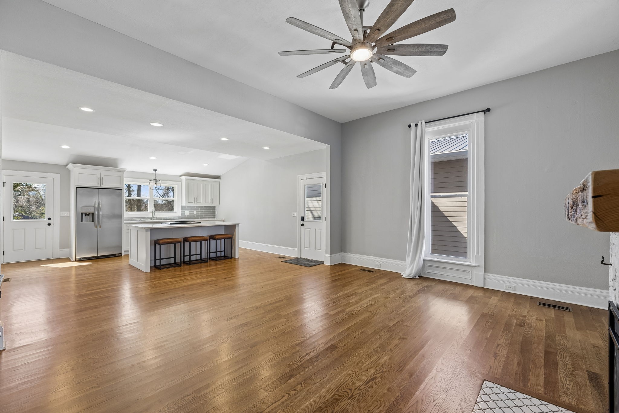 504 5th Avenue West Springfield, TN 37172 - Photo 9 of 57 a view of an empty room with wooden floor and a ceiling fan