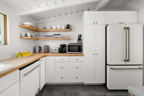 a kitchen with stainless steel appliances a refrigerator and cabinets