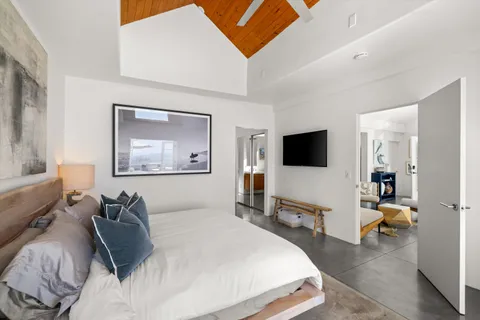 a bedroom with a bed and a flat screen tv