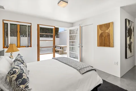 a bedroom with a large bed and a window