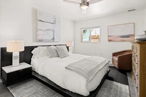 a bedroom with a bed and a chandelier