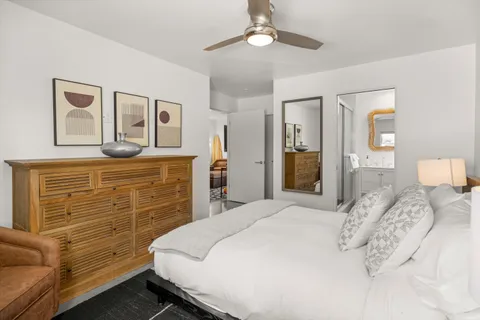 a bedroom with a bed and ceiling fan