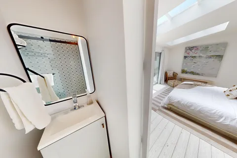 a bedroom with a bed and a mirror