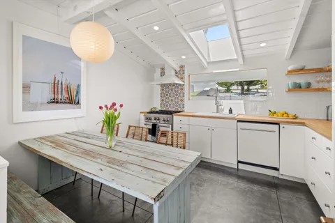 a kitchen with a table chairs and cabinets