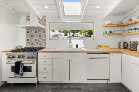 a kitchen with cabinets appliances and a counter top