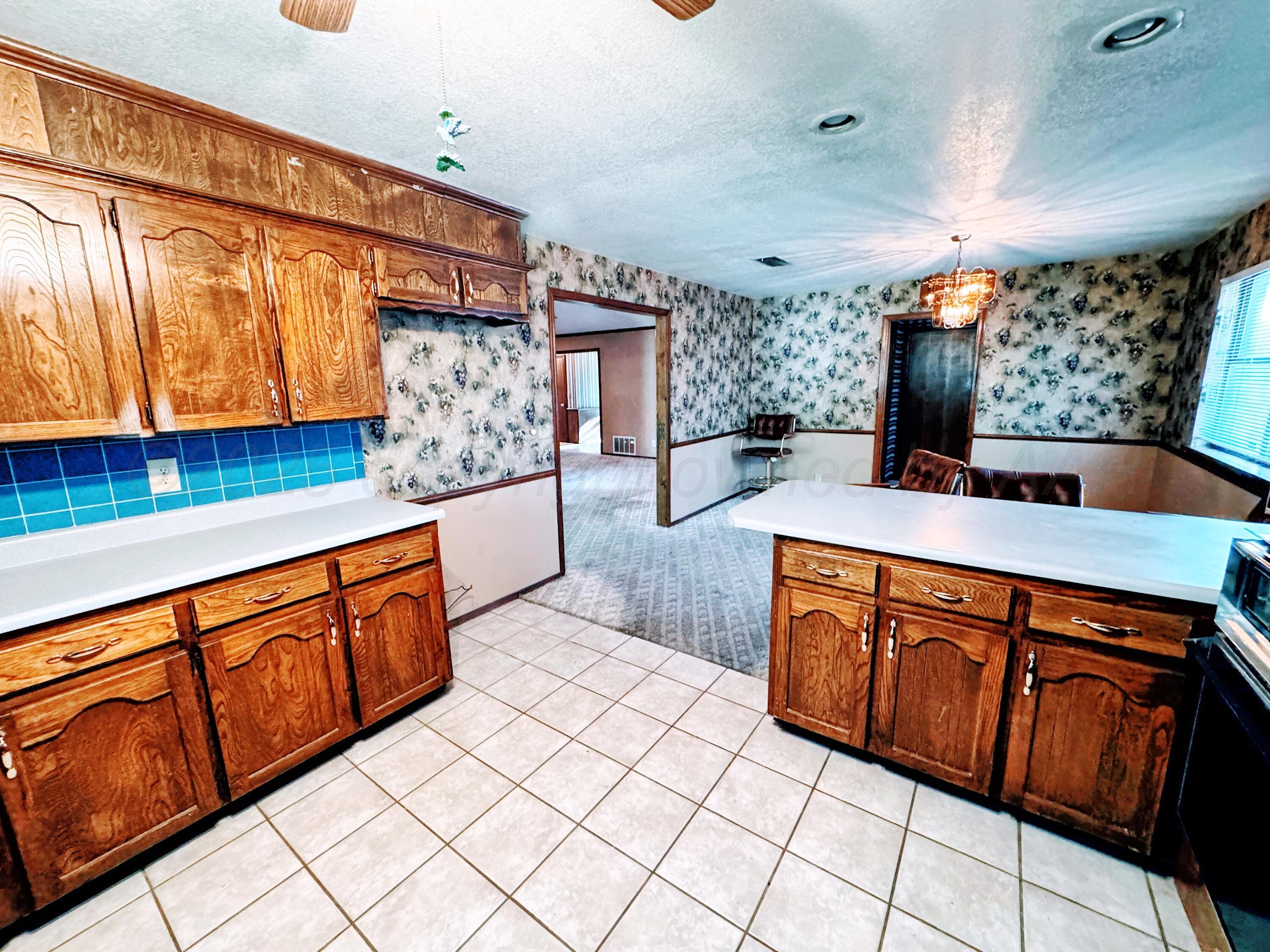 1905 Utah Street Perryton, TX 79070 - Photo 11 of 22 a kitchen with stainless steel appliances a sink and cabinets