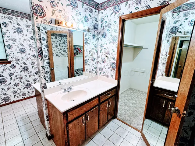 a bathroom with a sink a mirror and shower