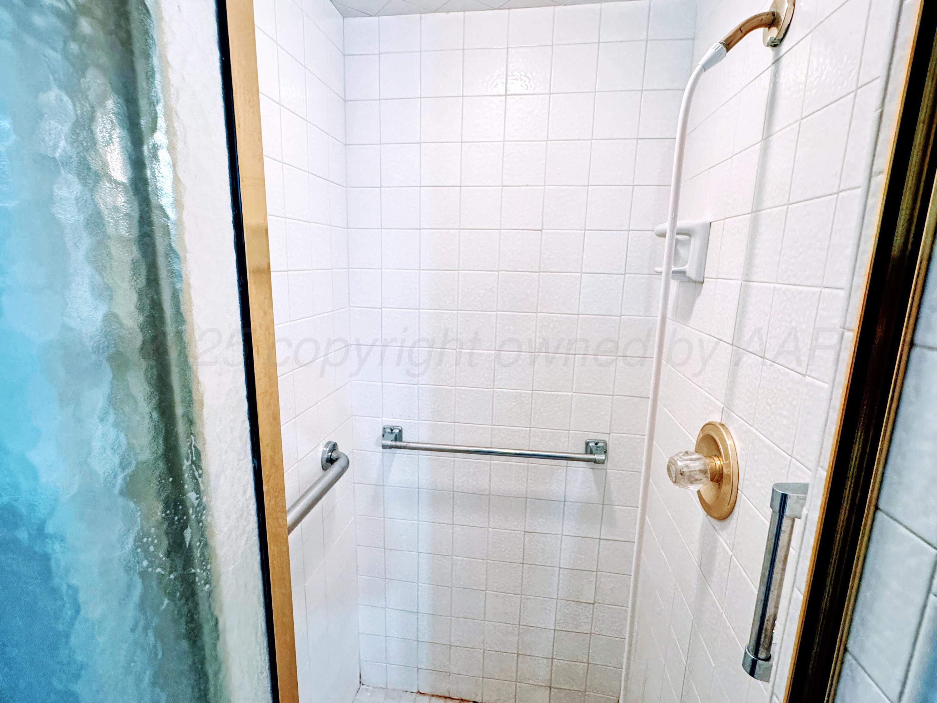 1905 Utah Street Perryton, TX 79070 - Photo 17 of 22 a bathroom with a shower
