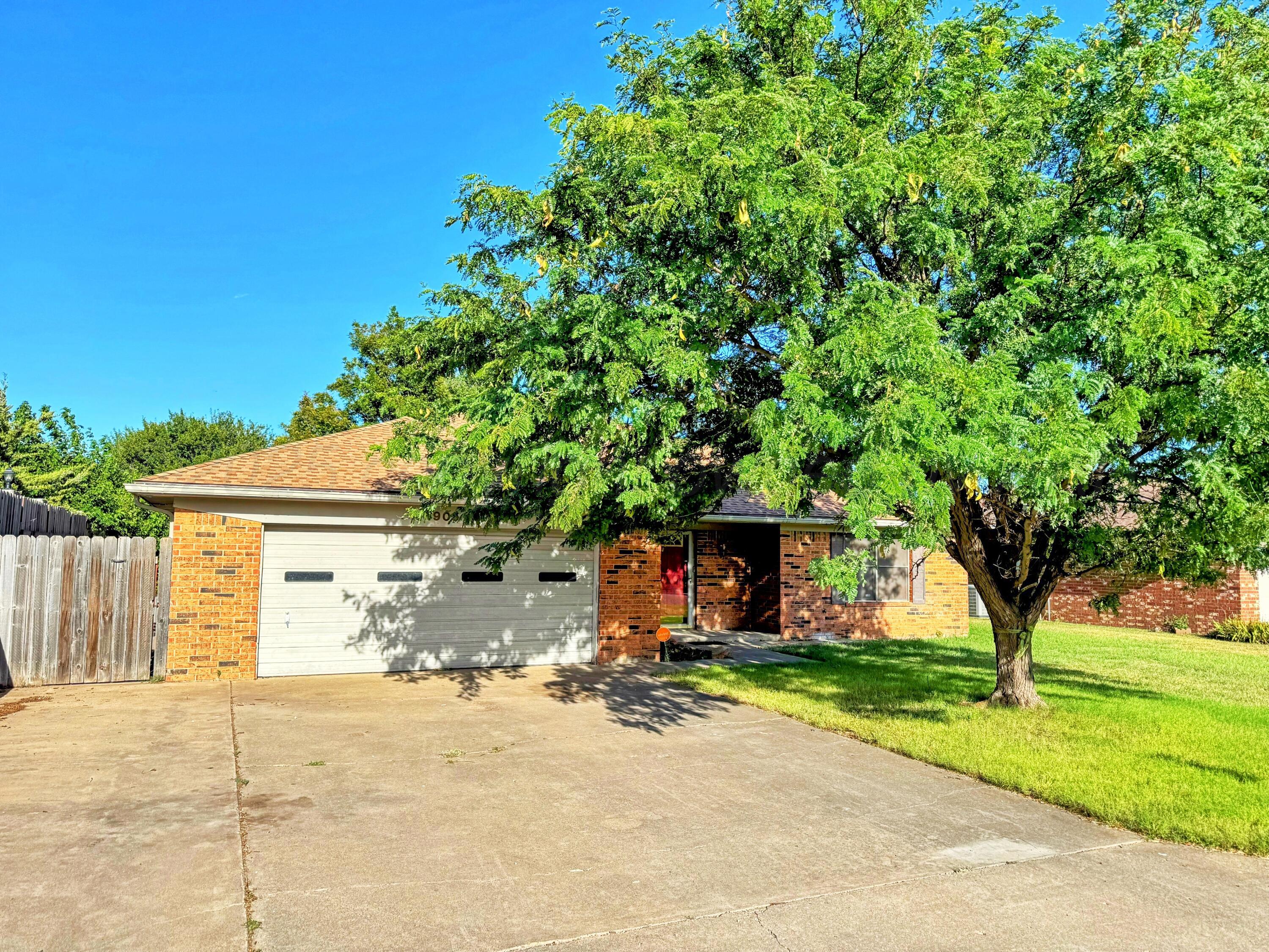 1905 Utah Street Perryton, TX 79070 - Photo 2 of 22 a front view of a house with a yard and garage