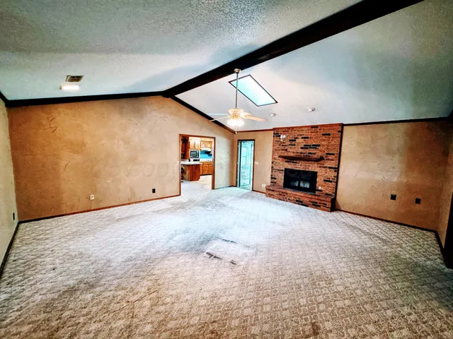 a view of an empty room with a fireplace