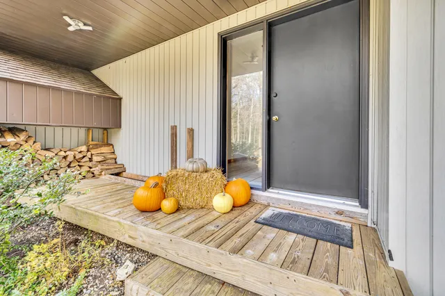 a front view of a house with a garden and trees