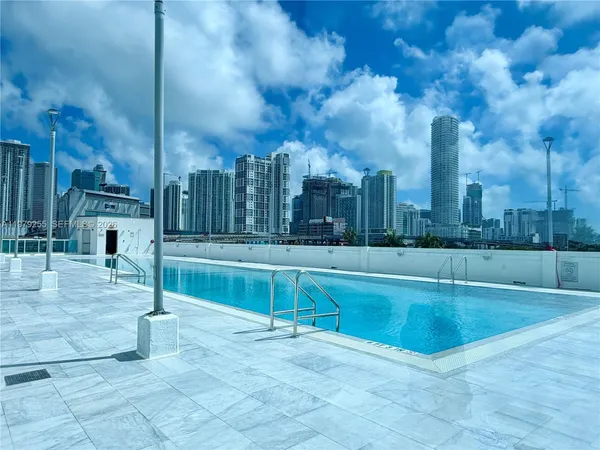 a view of a swimming pool with a yard