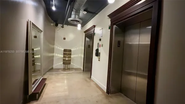 a view of a hallway with wooden shelves
