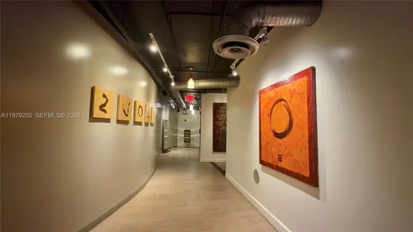 a hallway with painting on the wall