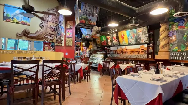 a view of a dining area with furniture and a chandelier