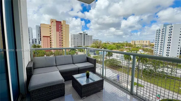 a balcony with furniture and city view