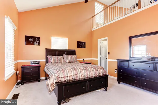 a room with a bed and a dresser