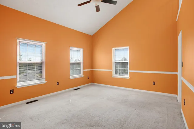 a view of a livingroom with a fireplace and a ceiling fan