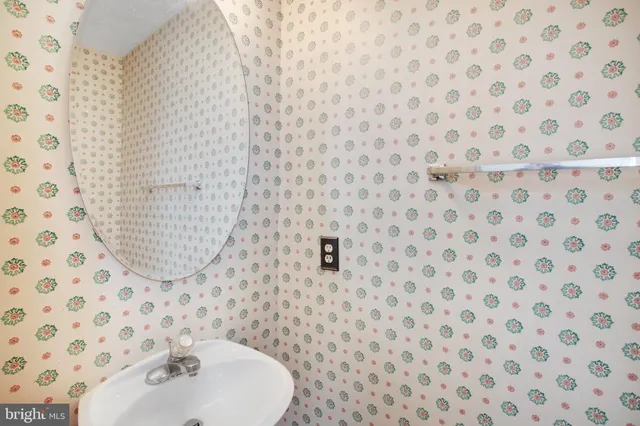 a bathroom with a sink a mirror and shower