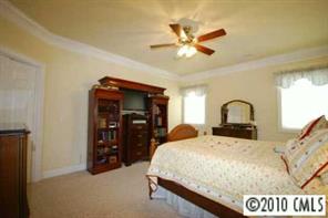 710 Beechnut Court Fort Mill, SC 29708 - Photo 6 of 8 a bedroom with a bed and ceiling fan