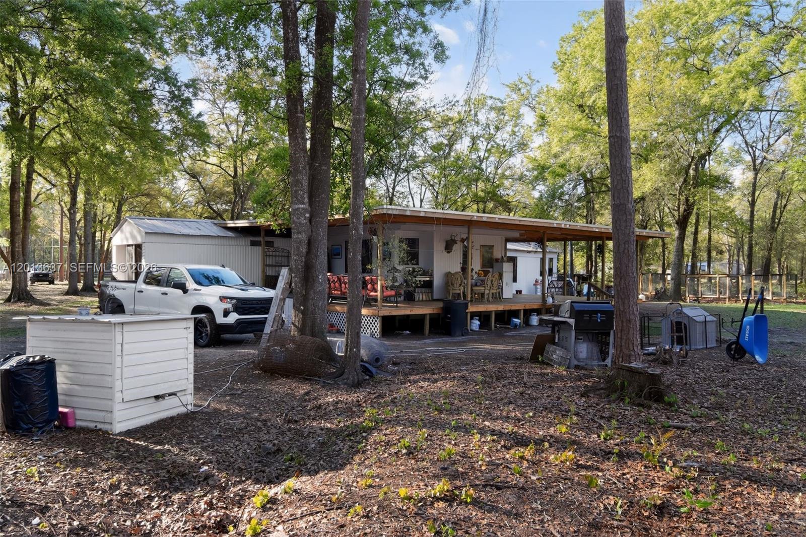2522 Northwest 121st Avenue Gainesville, FL 32609 - Photo 25 of 40 a view of a house with a backyard and sitting area