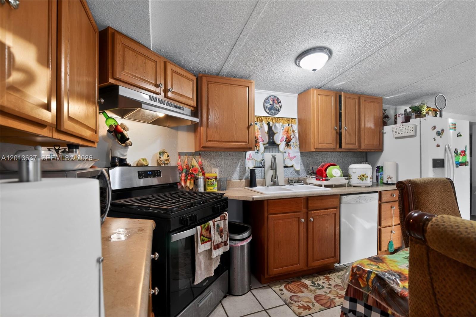2522 Northwest 121st Avenue Gainesville, FL 32609 - Photo 28 of 40 a kitchen with stainless steel appliances granite countertop a stove a sink dishwasher and cabinets with wooden floor