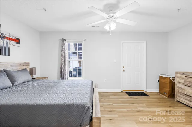 a bedroom with a bed and painting on the wall