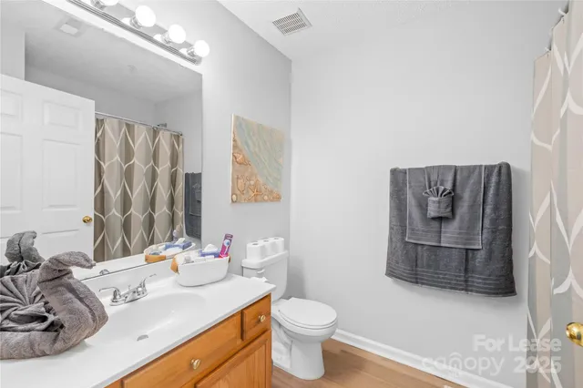 a bathroom with a sink toilet and mirror
