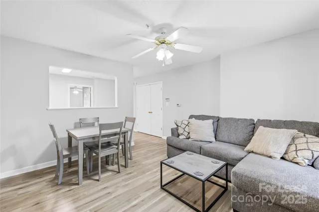 a living room with furniture and a wooden floor