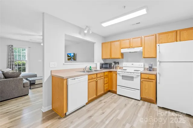 a kitchen with white cabinets and white appliances