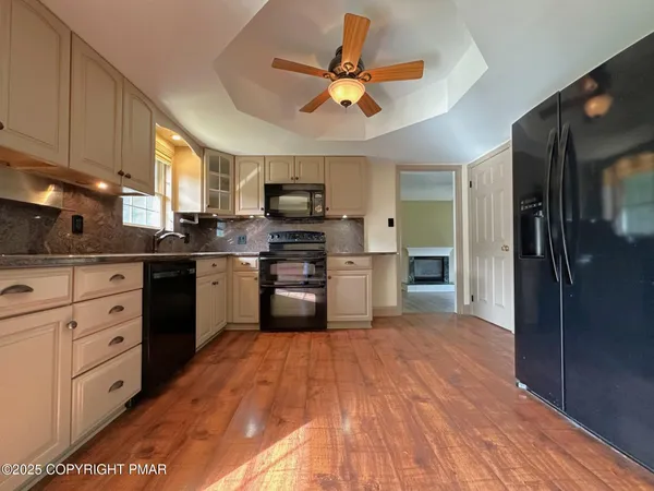 a kitchen with stainless steel appliances a refrigerator sink and cabinets