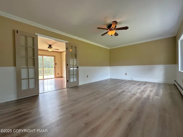 wooden floor in an empty room with a window