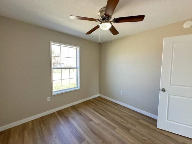 1107 North 4th Street Merkel, TX 79536 - Photo 12 of 16 an empty room with wooden floor fan and windows