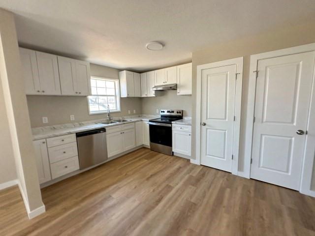 1107 North 4th Street Merkel, TX 79536 - Photo 9 of 16 a kitchen with white cabinets and white appliances