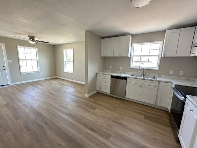 1107 North 4th Street Merkel, TX 79536 - Photo 10 of 16 a view of a kitchen with sink cabinets and wooden floor