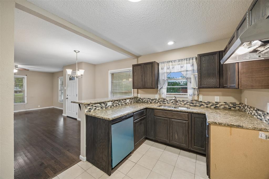 117 Moon Street Cleburne, TX 76033 - Photo 10 of 28 a kitchen with a sink stove and cabinets