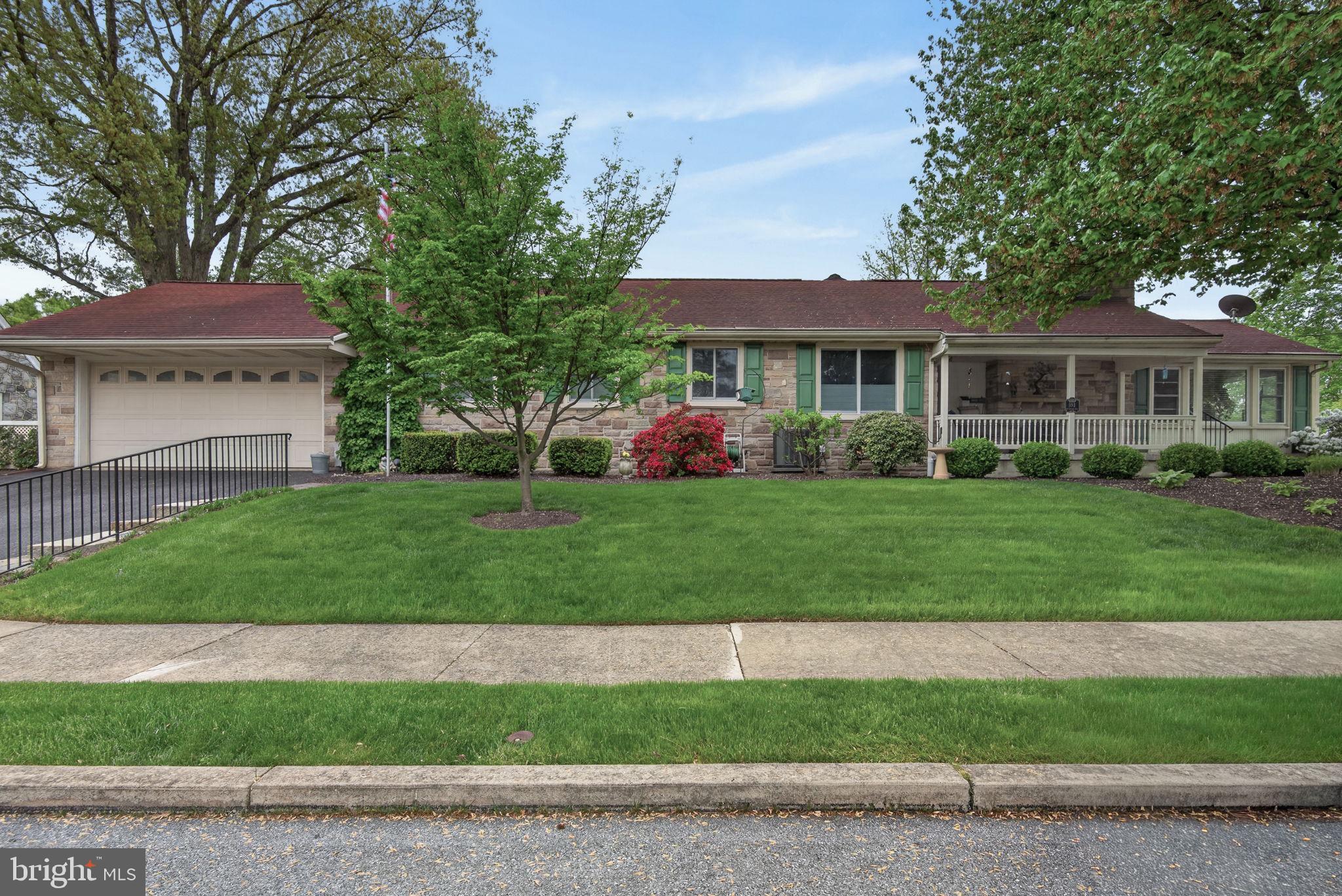 102 East Third Avenue Lititz, PA 17543 - Photo 1 of 45 a front view of a house with a garden and plants