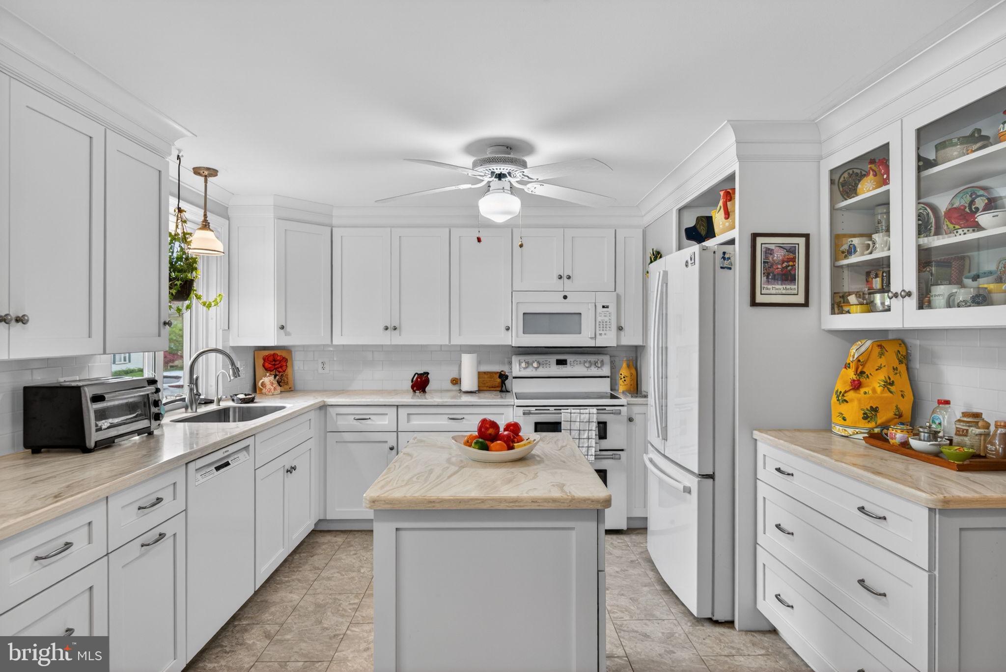102 East Third Avenue Lititz, PA 17543 - Photo 11 of 45 a kitchen with stainless steel appliances a stove a refrigerator and white cabinets