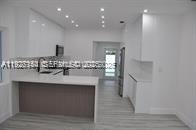 261 Northwest 46th Avenue, Unit 1 Miami, FL 33126 - Photo 2 of 10 a bathroom with a sink and a mirror